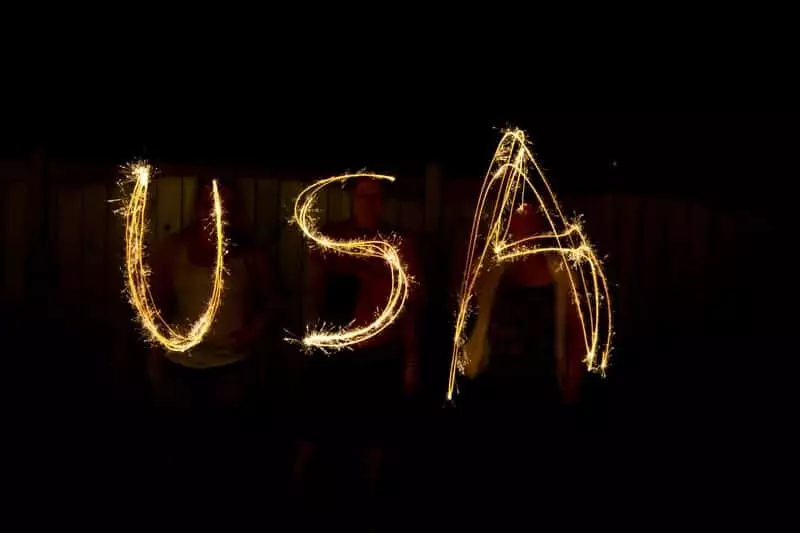 People writing USA in sparklers