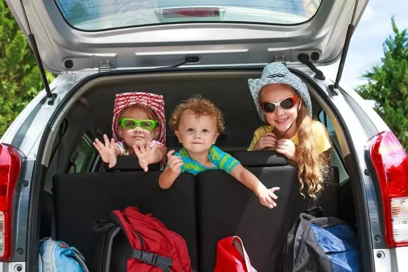 three kids in the back of the car on their way to a Smoky Mountain vacation