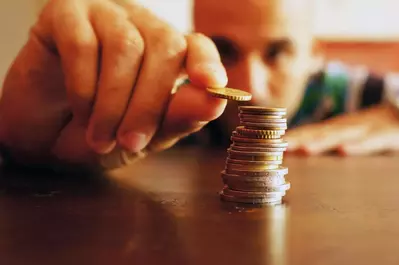Man counting coins on the table