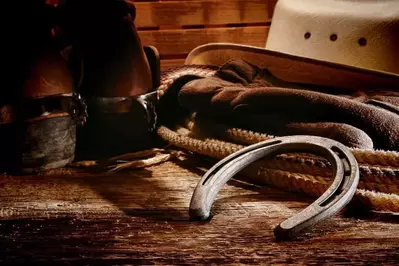 Cowboy hats, boots, lasso, and horse shoe for western horse riding