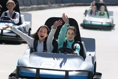 Two girls riding a go kart