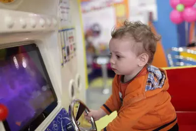 Baby playing arcade games