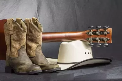 Country music icons, cowboy hat, cowboy boots, guitar