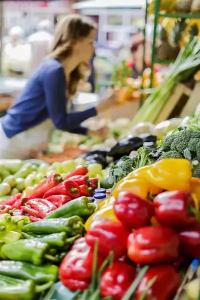 woman at a farmers market with fresh produce