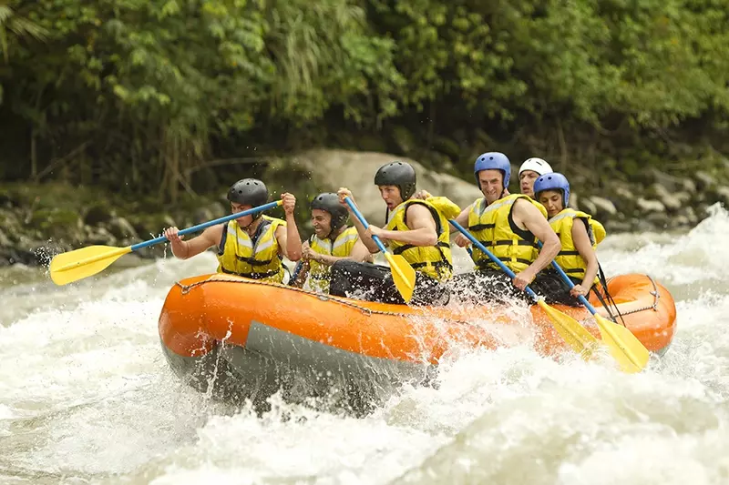 group of people white water rafting