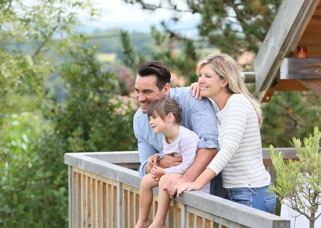 family standing on a deck of a pigeon forge cabin