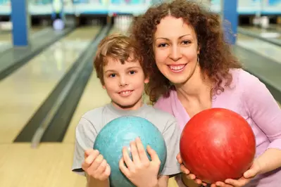 mother and son bowling
