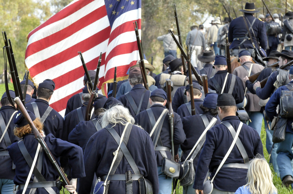 Civil War soldiers marching with the flag