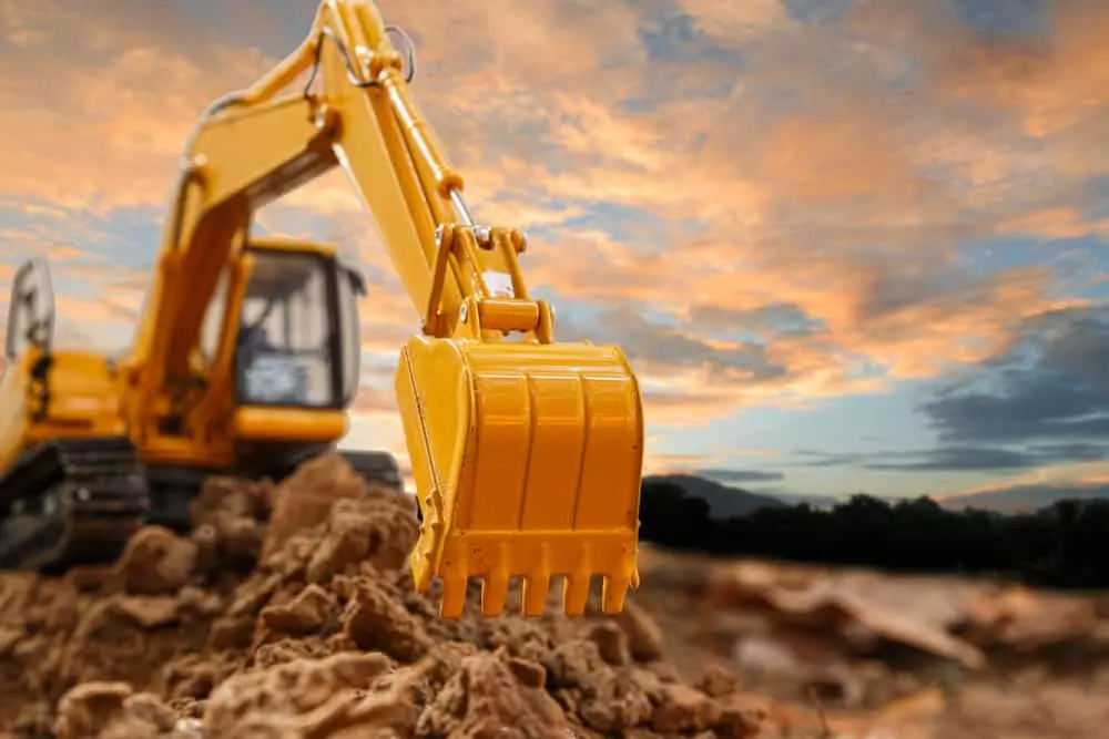 close up of excavator digging in dirt