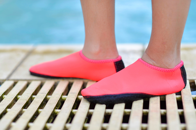 feet wearing pink water shoes