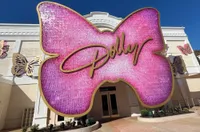 pink butterfly-shaped Dolly sign at the Dolly Parton Experience in Dollywood