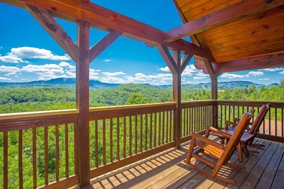 two chairs on the deck of a romantic Gatlinburg cabin with mountain views